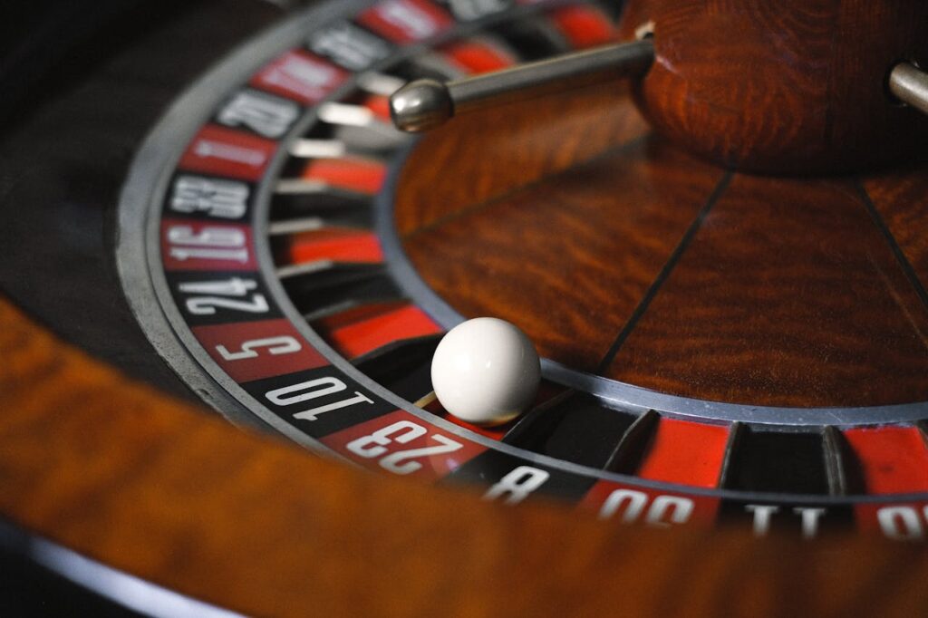 pexels-photo-6664249 Detailed close-up image of roulette wheel highlighting numbers and spinning ball in a casino setting.